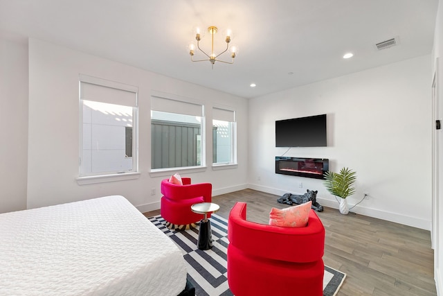 bedroom featuring a chandelier and wood-type flooring