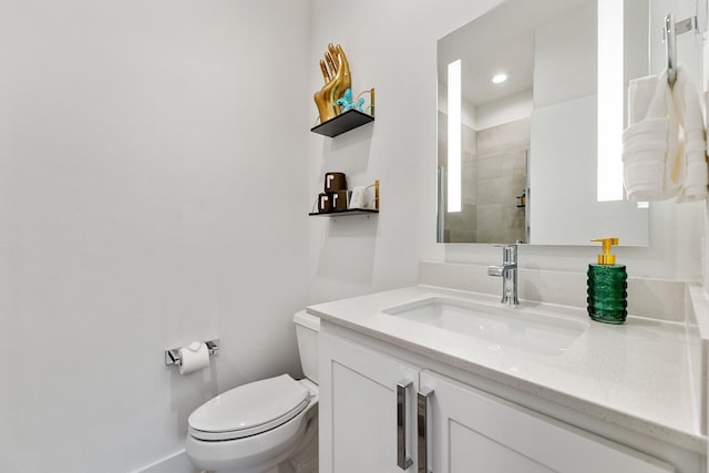 bathroom with vanity, toilet, and a shower with shower door