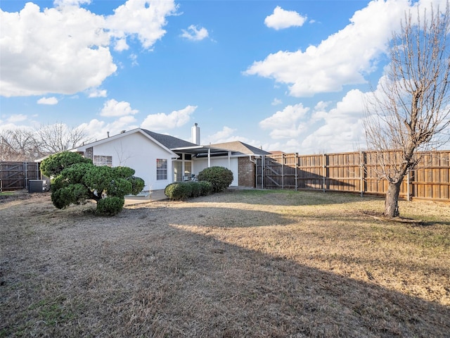 back of house with a lawn and central AC