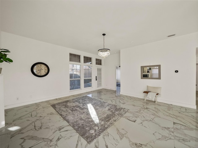 unfurnished dining area featuring a notable chandelier