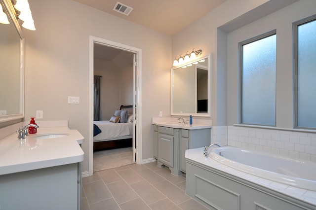 bathroom with vanity, a bathing tub, and tile patterned floors