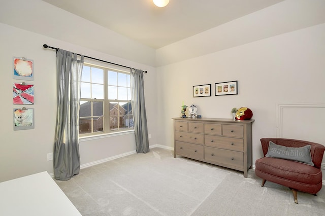 sitting room featuring light colored carpet