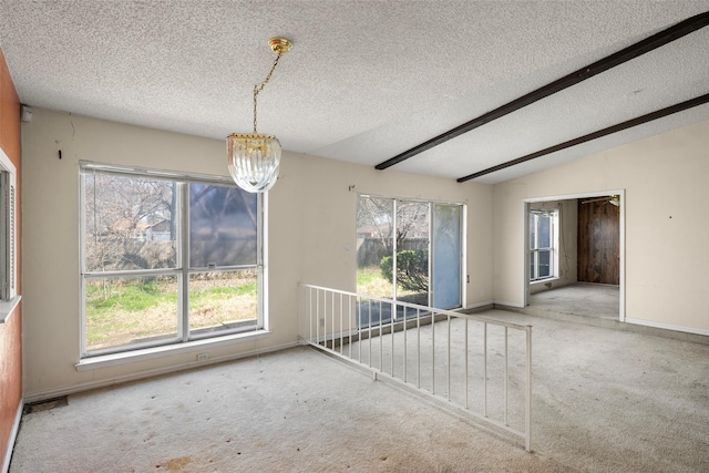 empty room featuring vaulted ceiling with beams, carpet, baseboards, and a notable chandelier