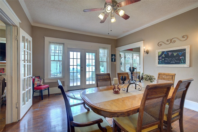 dining area featuring ornamental molding, french doors, a textured ceiling, and dark hardwood / wood-style floors