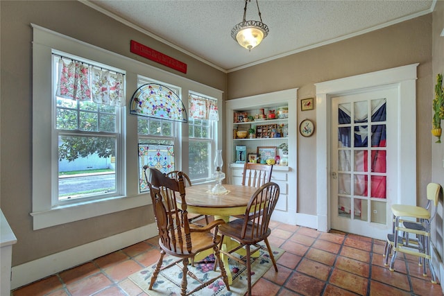 dining room featuring a textured ceiling, ornamental molding, a healthy amount of sunlight, and tile patterned floors