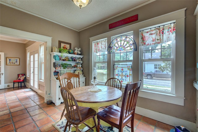 dining space featuring ornamental molding and a textured ceiling