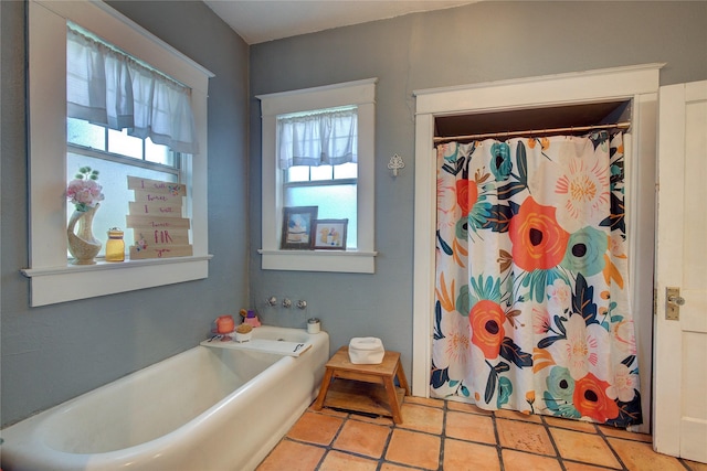 bathroom featuring plenty of natural light, plus walk in shower, and tile patterned flooring