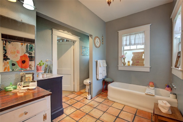 bathroom featuring vanity, tile patterned flooring, and a bathtub