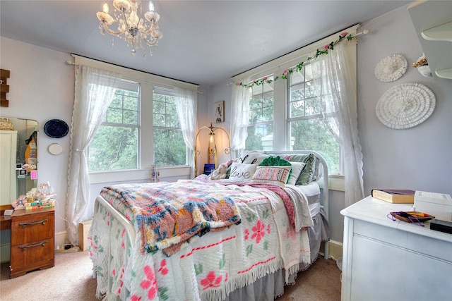 carpeted bedroom featuring a chandelier