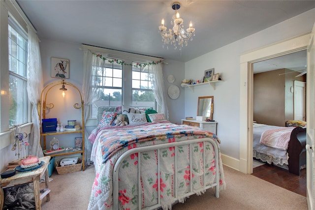 bedroom featuring a chandelier and carpet flooring