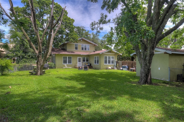 rear view of house with a lawn