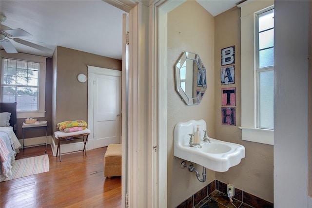 bathroom featuring hardwood / wood-style floors, ceiling fan, and sink