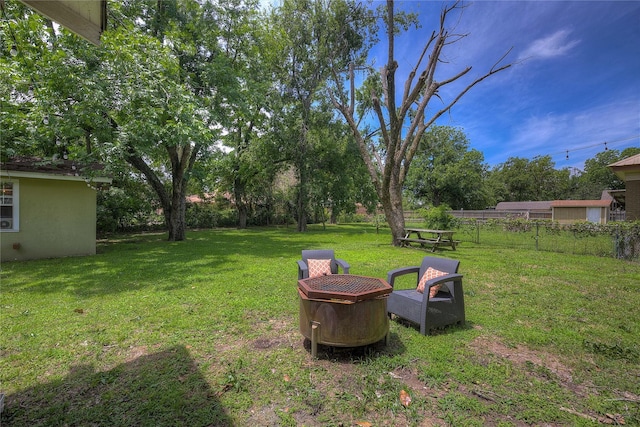 view of yard with a fire pit