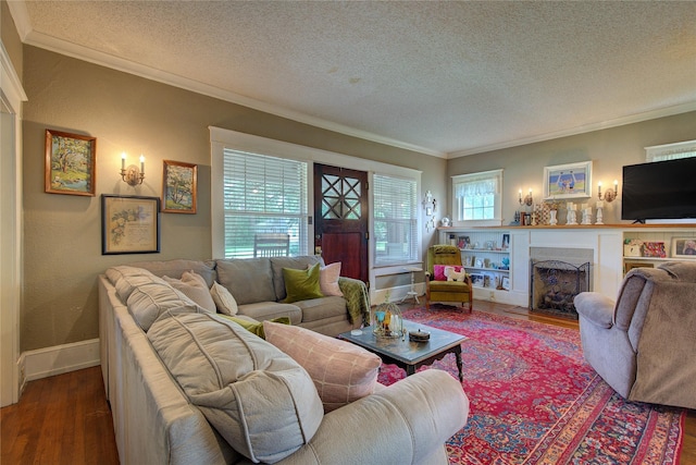 living room featuring a textured ceiling, ornamental molding, and hardwood / wood-style floors