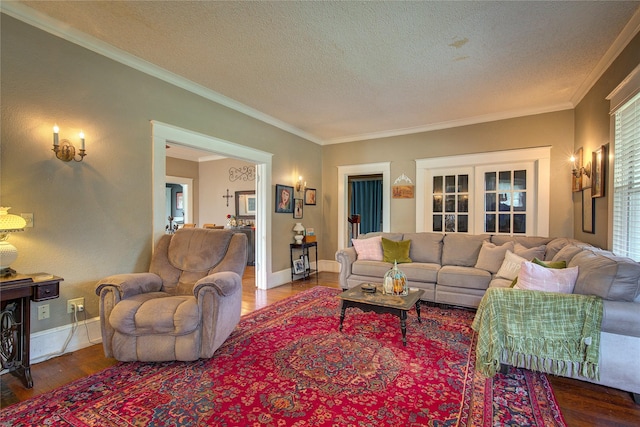 living room with ornamental molding, wood-type flooring, and a textured ceiling