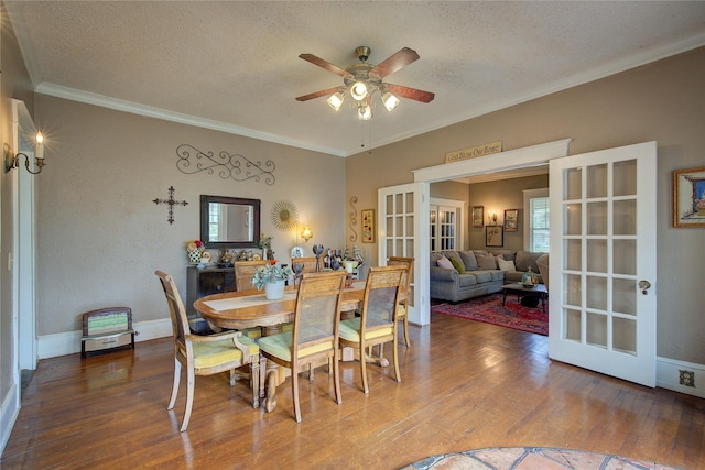 dining area with hardwood / wood-style flooring, ceiling fan, crown molding, and a textured ceiling