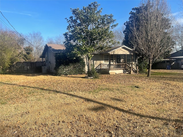 exterior space featuring fence and a deck