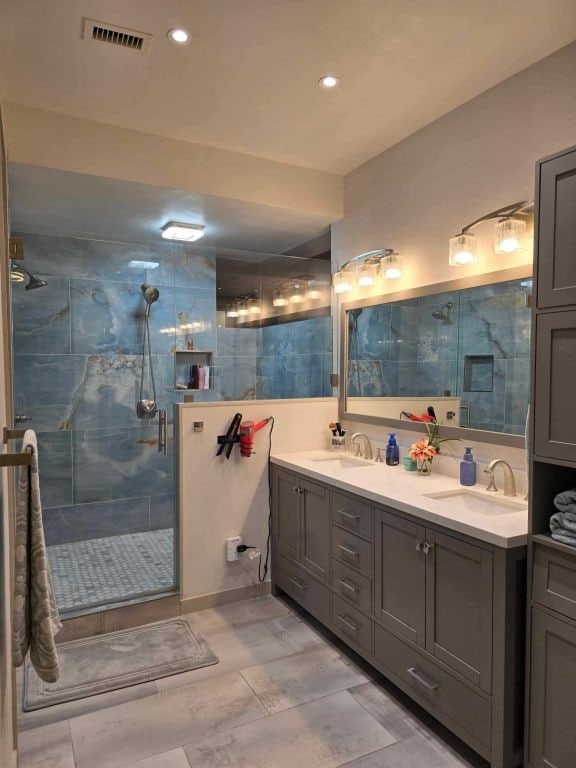 bathroom with an enclosed shower and vanity