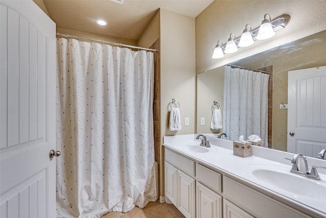 5320 Locust Dr, Mckinney, TX 75070 - full bath featuring tile patterned flooring, double vanity, a shower with curtain, and recessed lighting