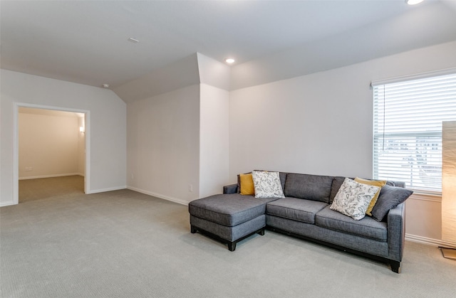 carpeted living room featuring vaulted ceiling