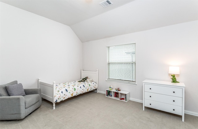 carpeted bedroom with lofted ceiling