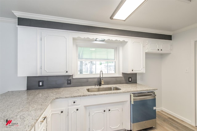 kitchen with sink, crown molding, stainless steel dishwasher, and white cabinetry