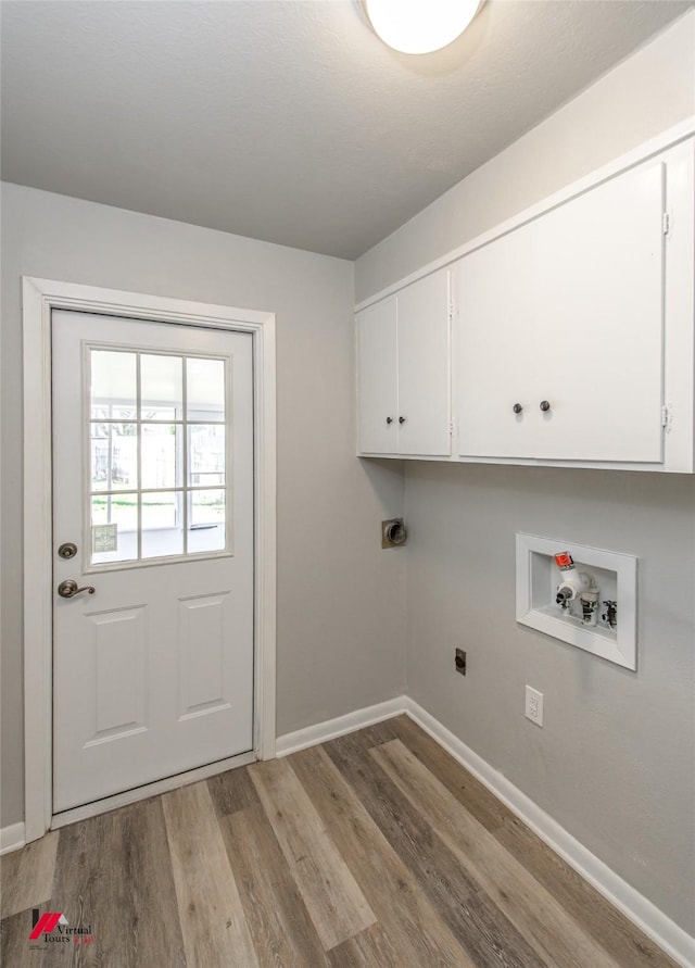 clothes washing area featuring cabinets, hookup for an electric dryer, hookup for a washing machine, and light hardwood / wood-style floors