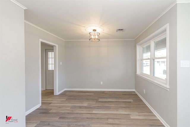 unfurnished room featuring hardwood / wood-style floors and crown molding