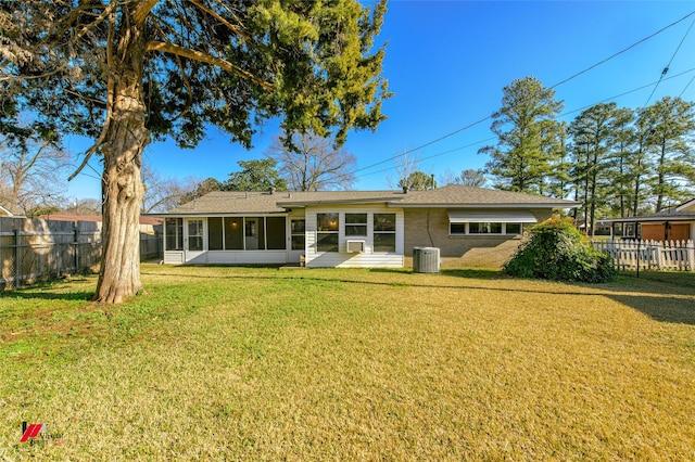 back of house featuring central AC, a yard, and a sunroom