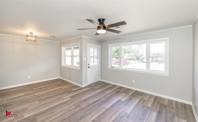 unfurnished room featuring hardwood / wood-style floors, ceiling fan, and crown molding