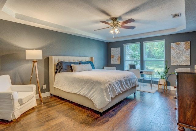 2248 Dorrington Dr, Dallas, TX 75228 - bedroom featuring wood finished floors, a raised ceiling, baseboards, a textured ceiling, and a ceiling fan