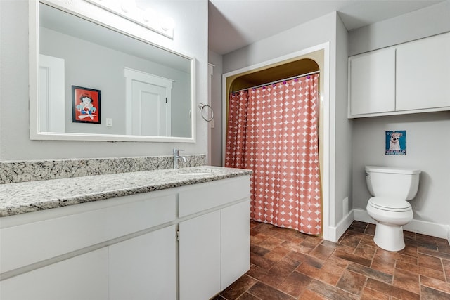 2248 Dorrington Dr, Dallas, TX 75228 - bathroom with stone finish flooring, vanity, toilet, baseboards, and curtained shower