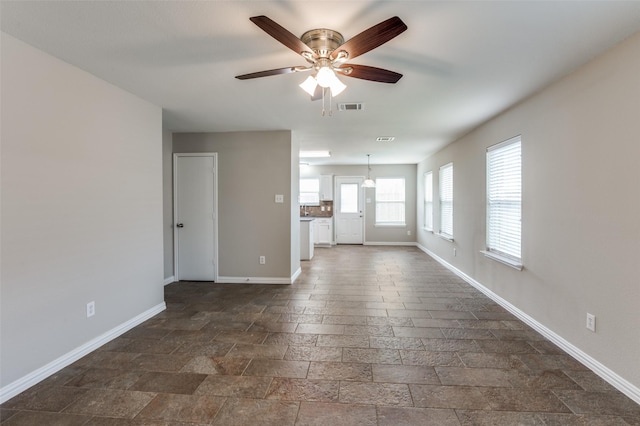 unfurnished living room featuring ceiling fan