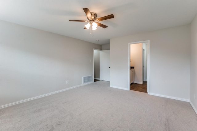 unfurnished bedroom featuring ceiling fan, ensuite bath, and carpet floors