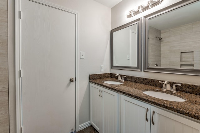 bathroom featuring vanity and a tile shower