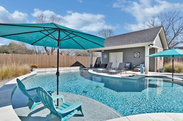 view of swimming pool featuring an outbuilding and a patio