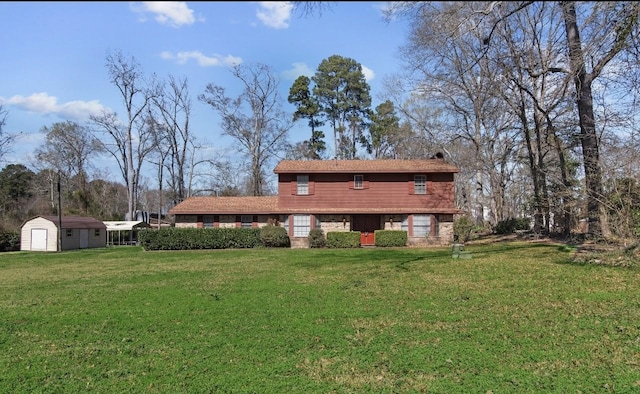 back of house with a shed and a lawn