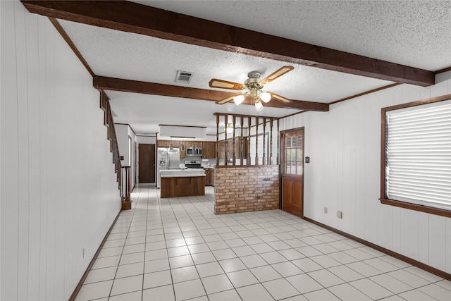 5570 Bretwood Dr, Keithville, LA 71047 - unfurnished living room featuring light tile patterned flooring, ceiling fan, beamed ceiling, and a textured ceiling