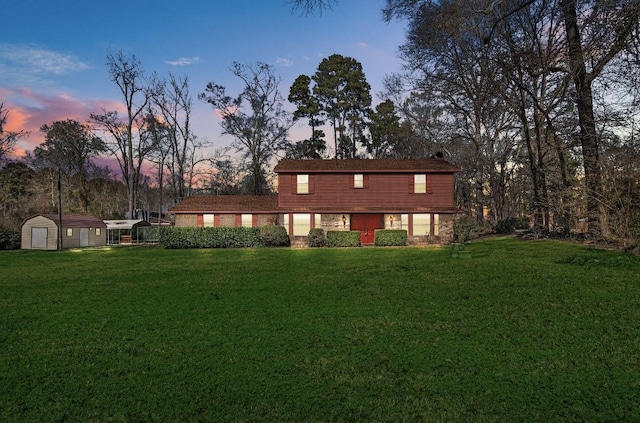 front facade with a lawn and a storage unit