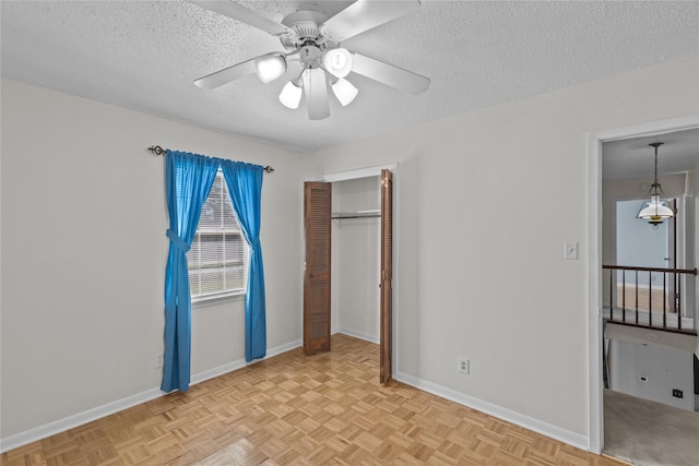 5570 Bretwood Dr, Keithville, LA 71047 - unfurnished bedroom with ceiling fan, light parquet flooring, a textured ceiling, and a closet
