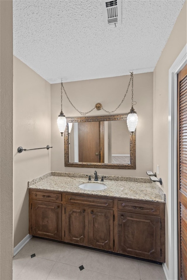 5570 Bretwood Dr, Keithville, LA 71047 - bathroom featuring tile patterned floors, a textured ceiling, and vanity