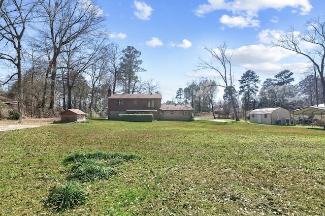 5570 Bretwood Dr, Keithville, LA 71047 - view of yard featuring a storage unit and a carport
