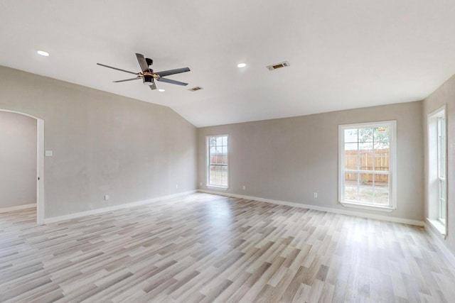 unfurnished room featuring light hardwood / wood-style flooring, ceiling fan, and vaulted ceiling