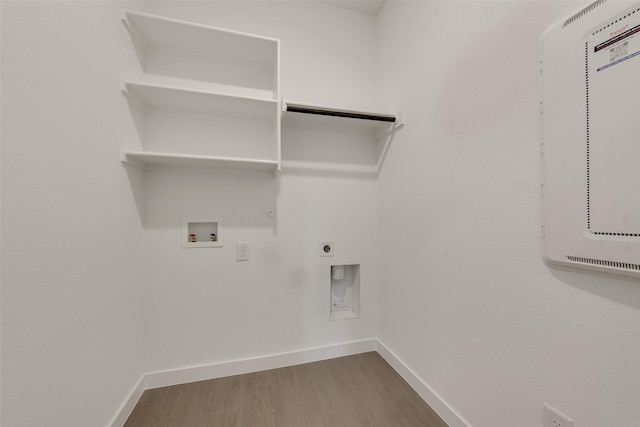 laundry room with laundry area, hookup for a washing machine, wood finished floors, hookup for a gas dryer, and baseboards