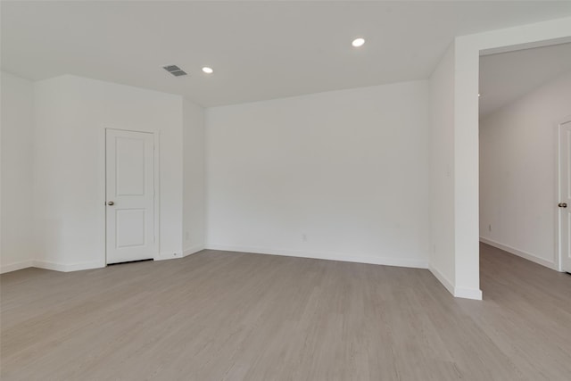 empty room featuring light wood-style floors, baseboards, and recessed lighting