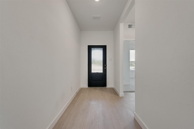 entryway with visible vents, baseboards, and light wood-type flooring