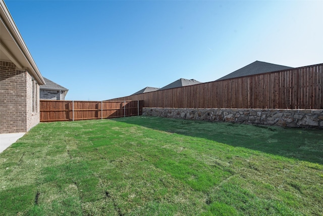 view of yard with a fenced backyard