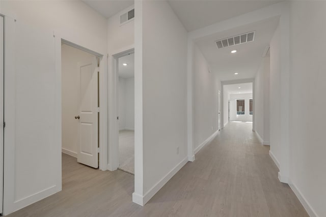 hallway featuring recessed lighting, visible vents, light wood-type flooring, and baseboards