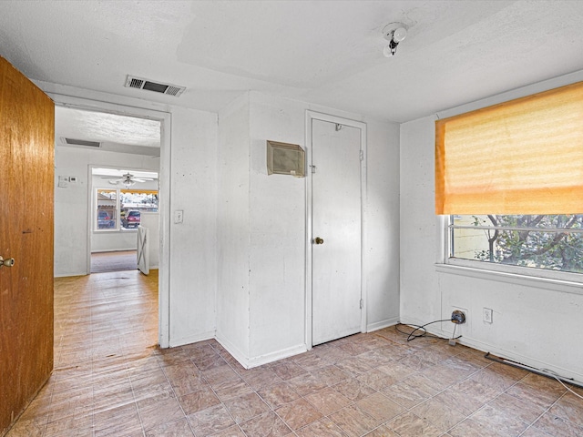 unfurnished room featuring a textured ceiling