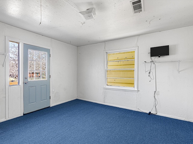 unfurnished room with dark carpet